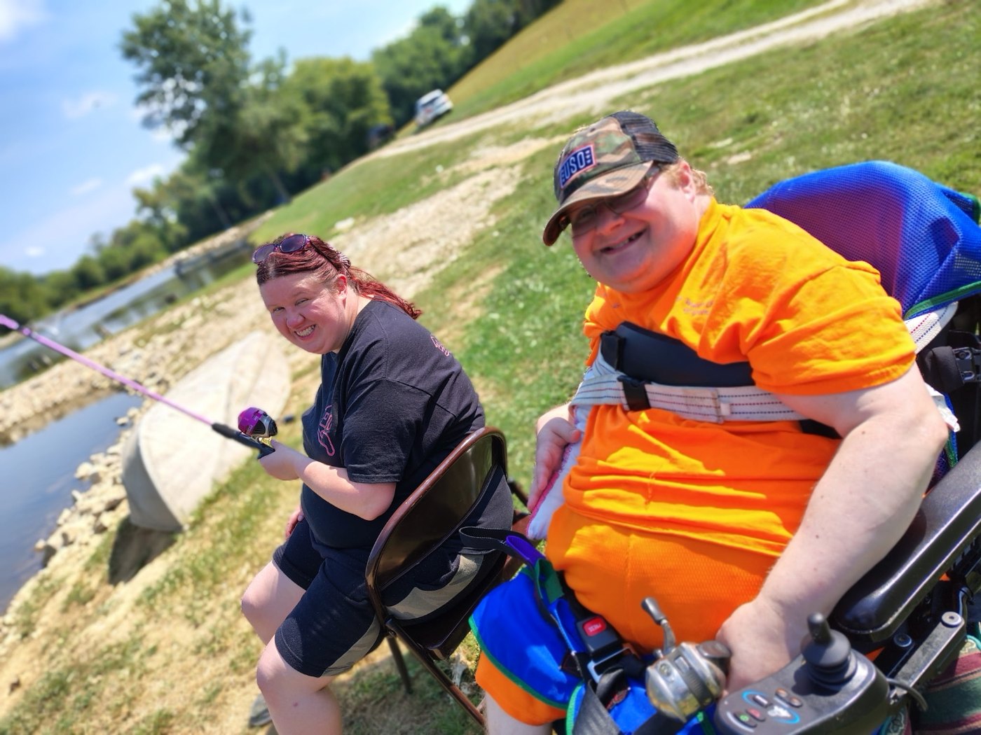 A Golden Years member and caregiver enjoying a fishing outing by the water